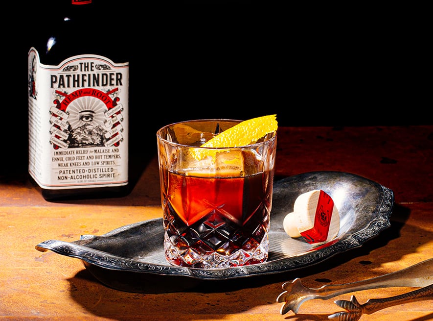 Finder's Old Fashioned in a tumbler next to a bottle of The Pathfinder spirit
